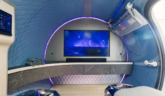 Blue quilted interior with a media wall and marble console
