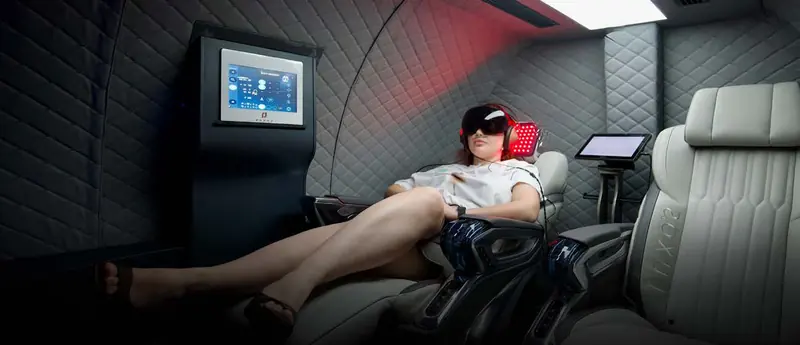 Guest reclining with light goggles, headphones and a red light head panel
