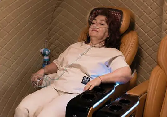 Guest resting in a recliner with an oxygen cannula