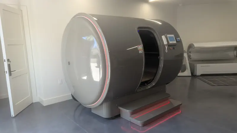 5Lifetech chamber in grey with red light lines, door open, installed in a private room