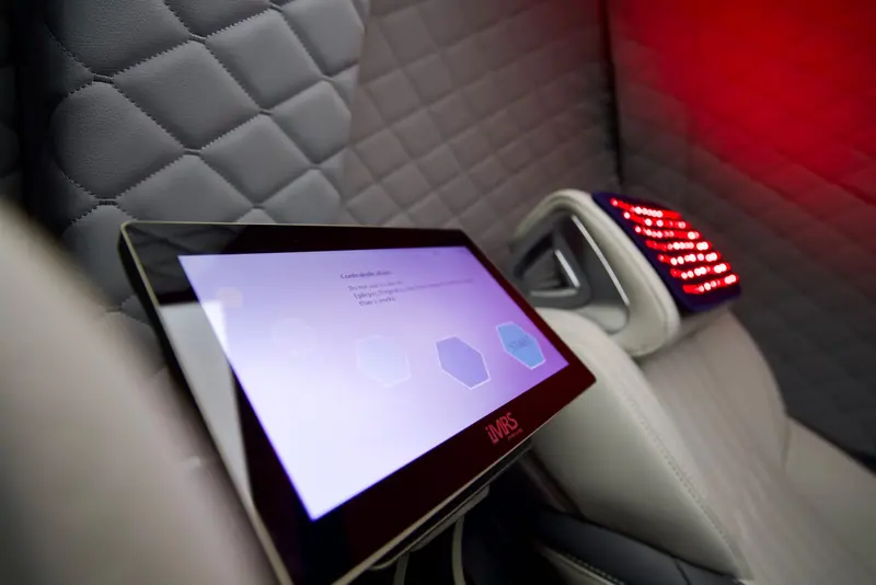 Swiss Bionic iMRS prime touchscreen beside a recliner with a red light head panel